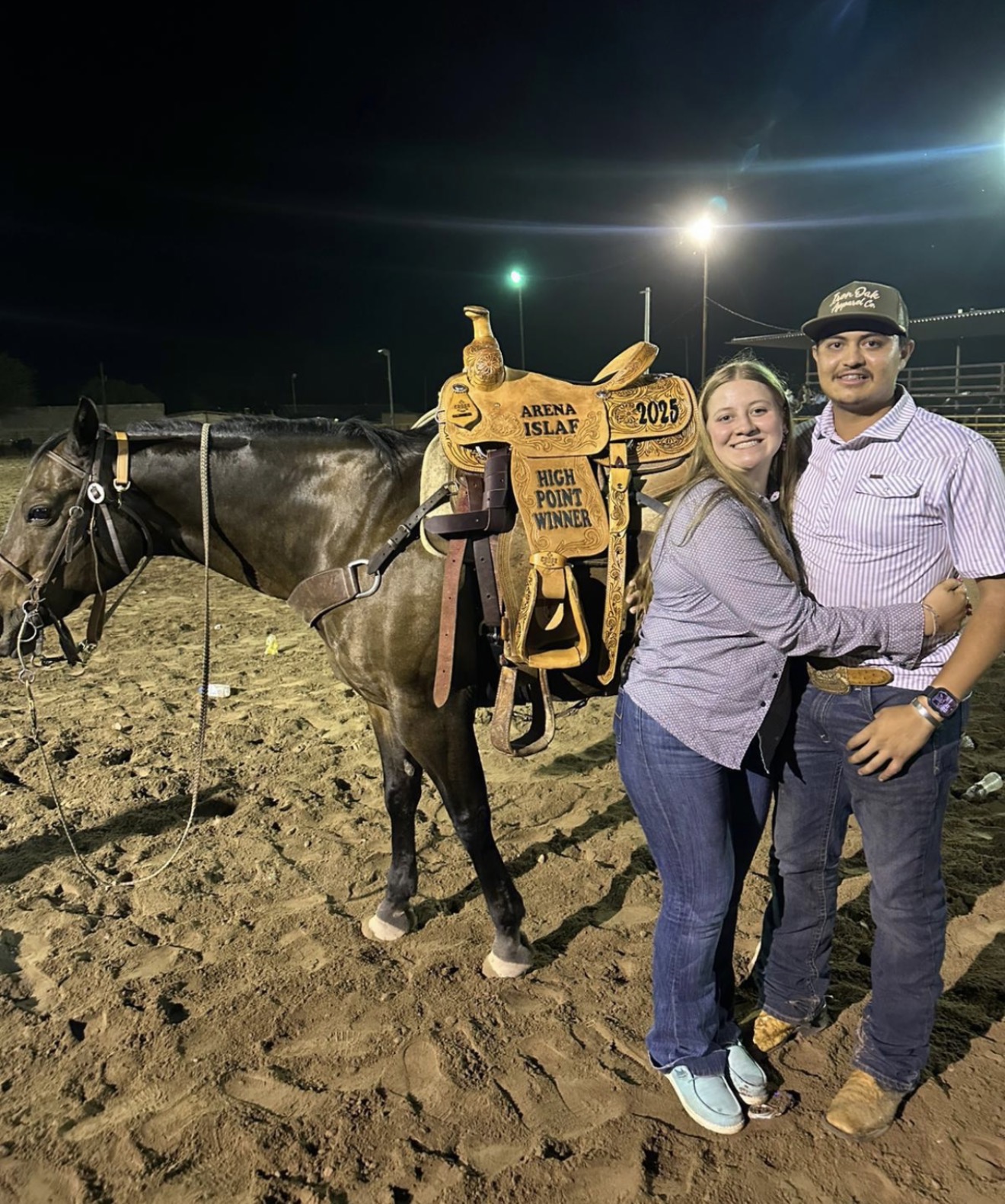 Julian with horse and high point winner saddle at a roping arena